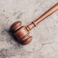Judge's gavel on a stone benchtop